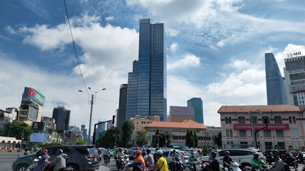 a group of people riding motorcycles down a street