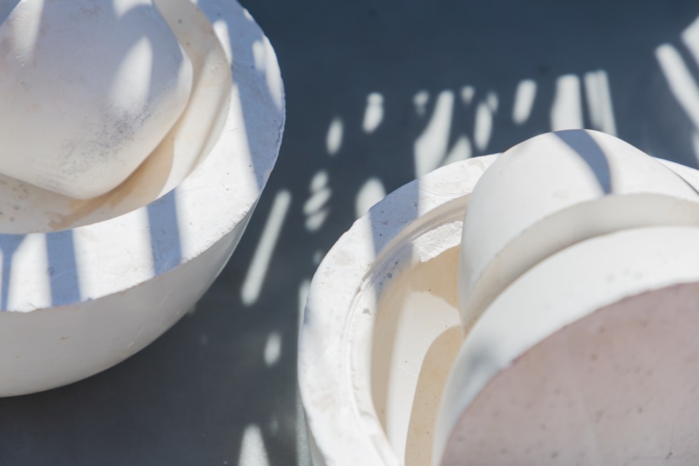 a couple of white bowls sitting on top of a table