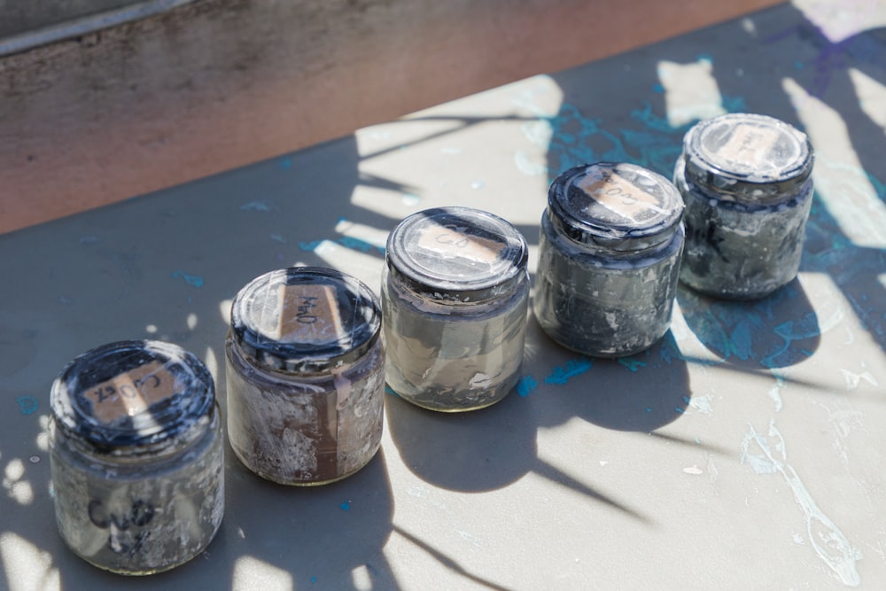 a group of jars sitting on top of a table