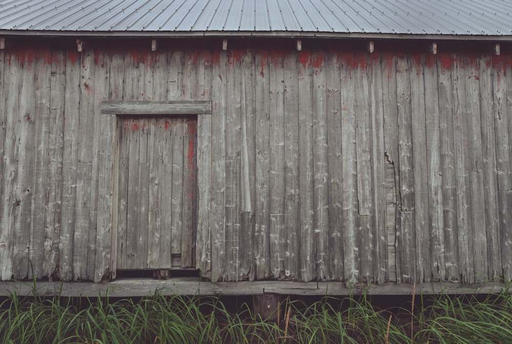 an old weathered barn with a wooden door