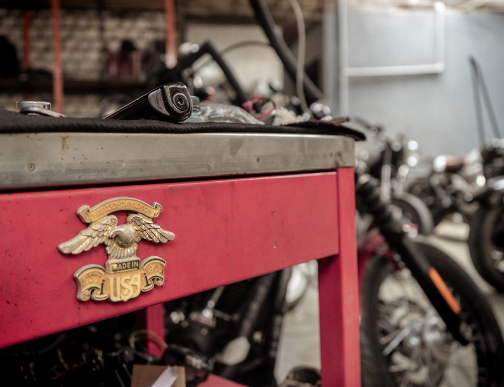 a close up of a red table with motorcycles in the background