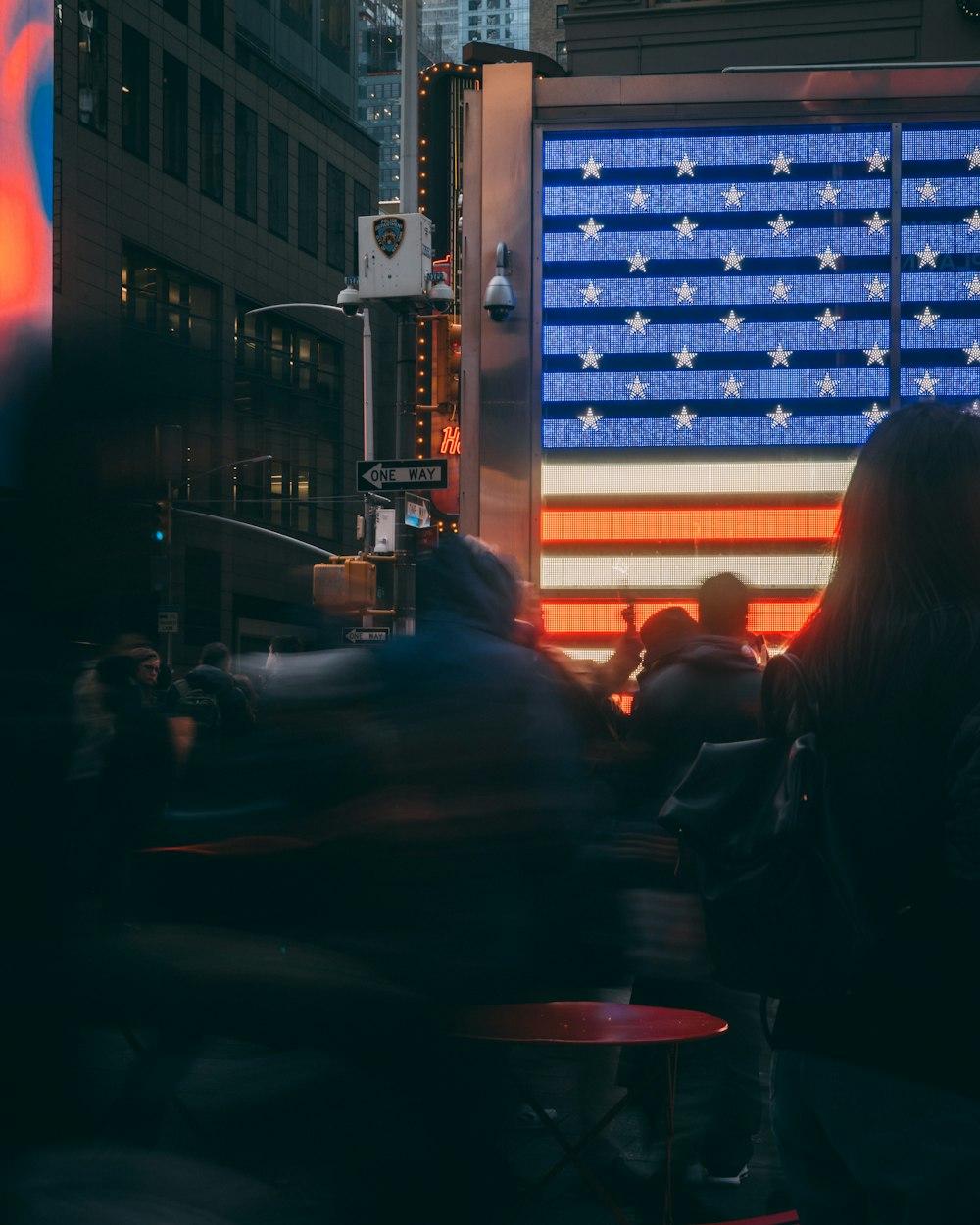 a large american flag is projected on the side of a building