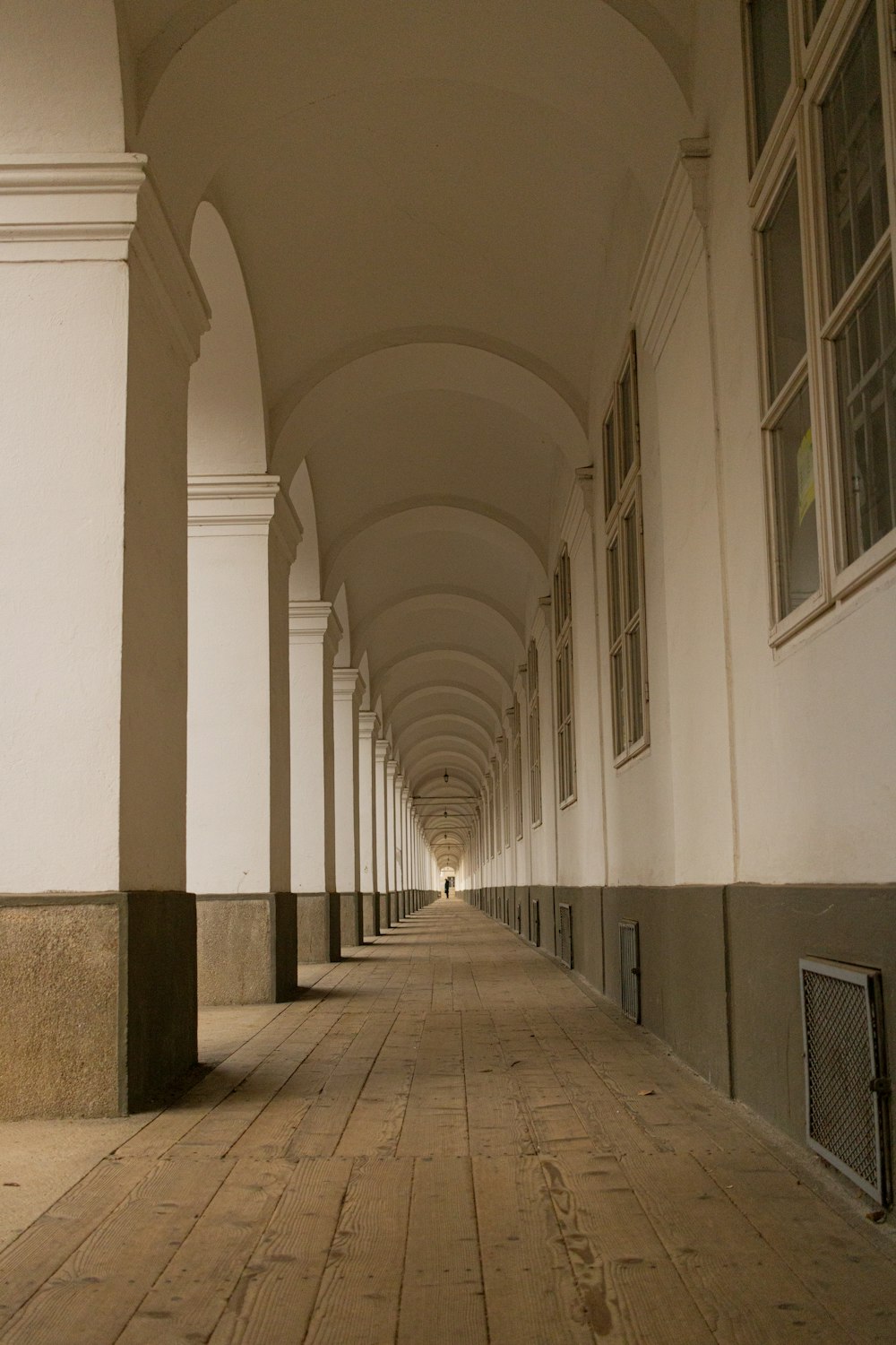 a long hallway with a clock on the side of it