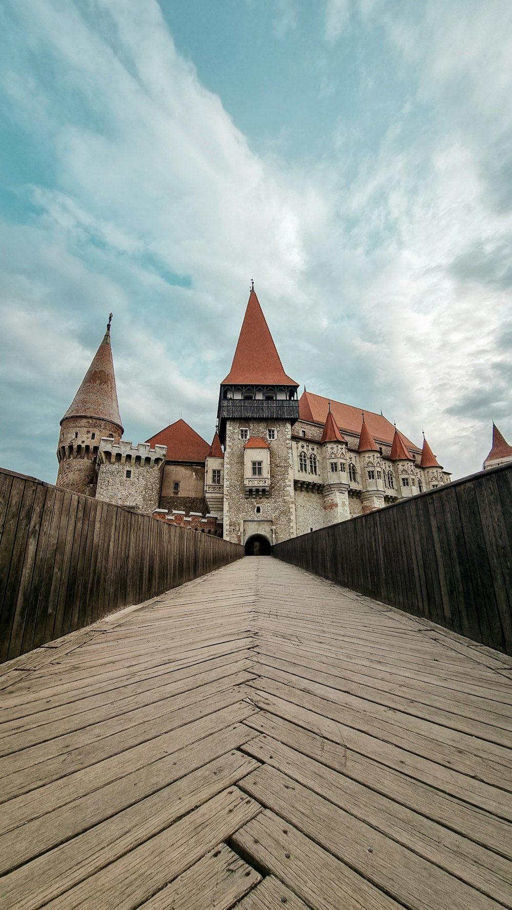a wooden walkway leading to a castle like building