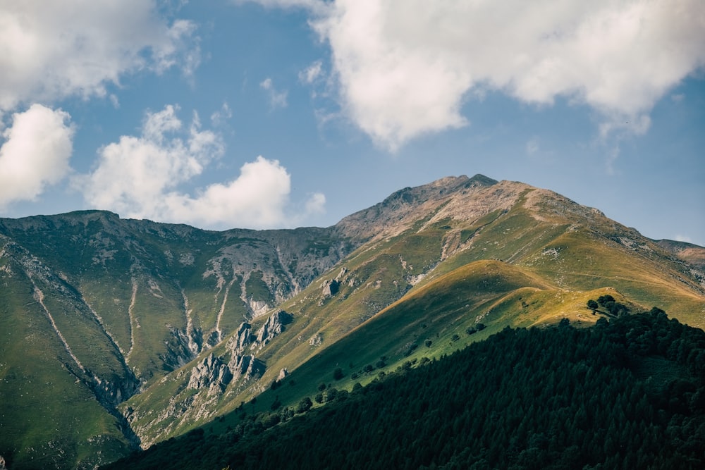 a view of a mountain range with clouds in the sky