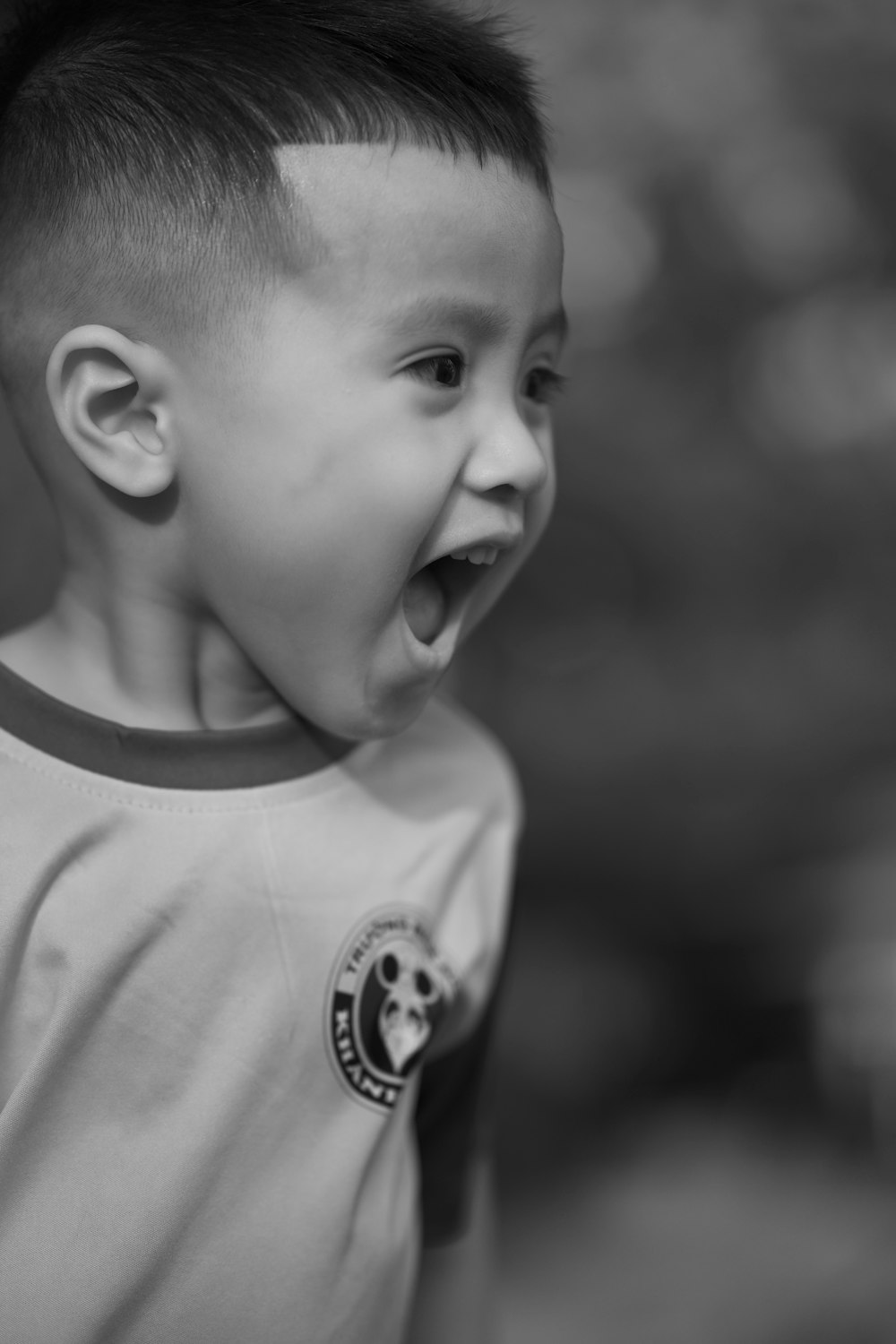 a young boy making a funny face with his mouth open