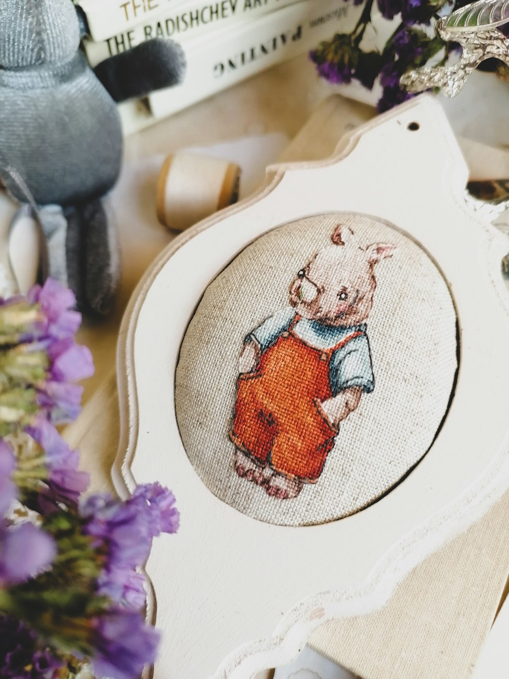 a cross stitch picture of a teddy bear