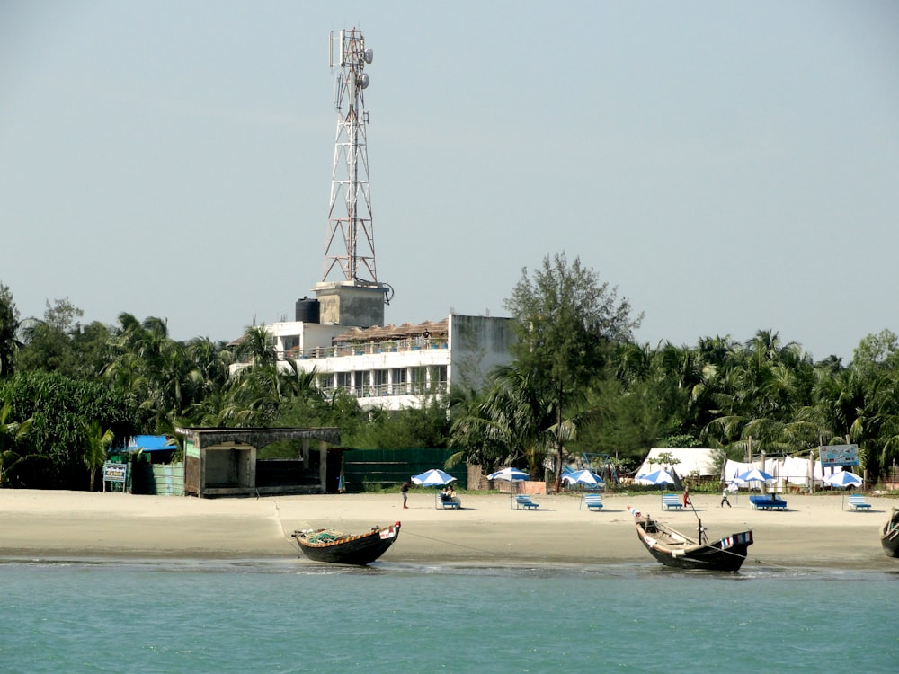 a group of boats sitting on top of a sandy beach