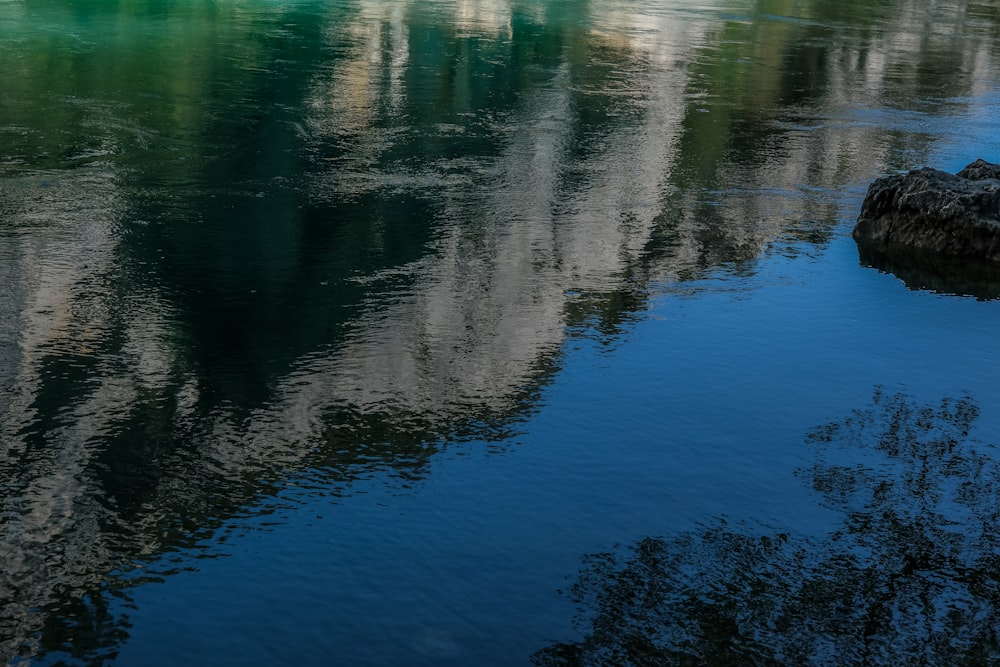 a body of water with a mountain in the background