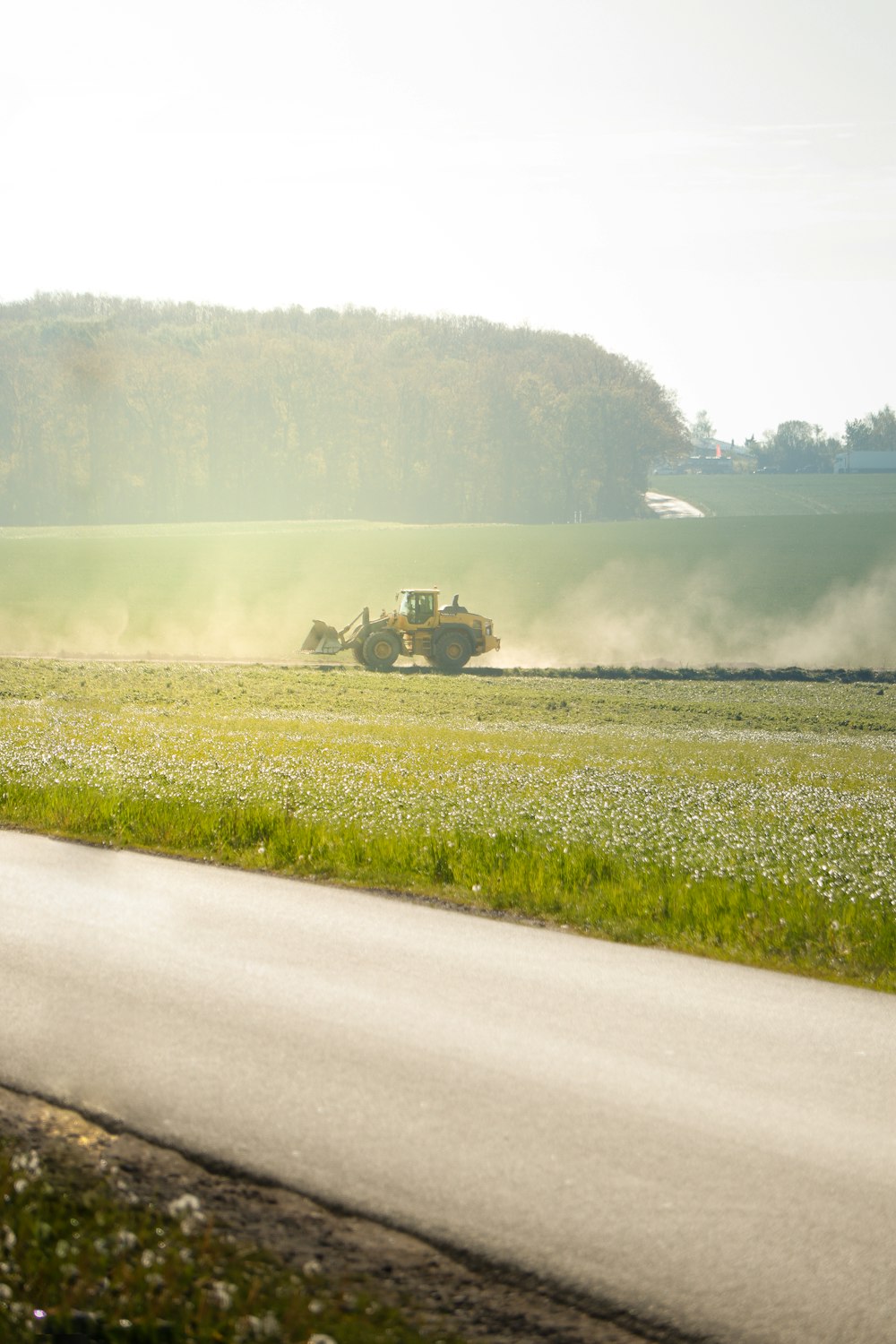 a tractor is driving down a country road