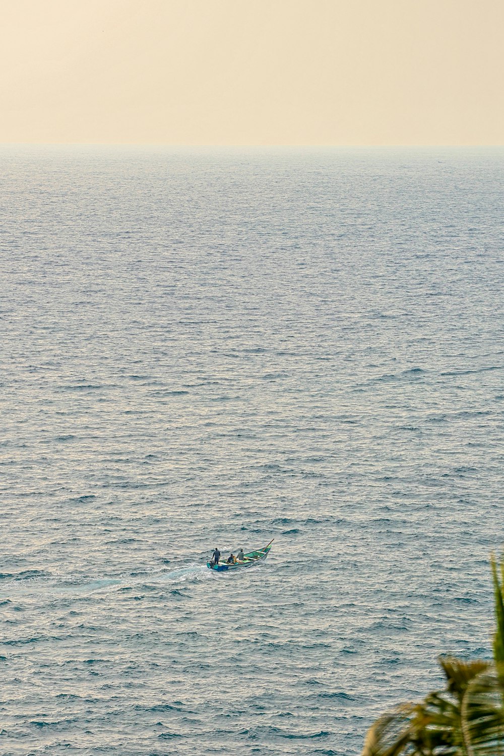 two people in a boat in the middle of the ocean