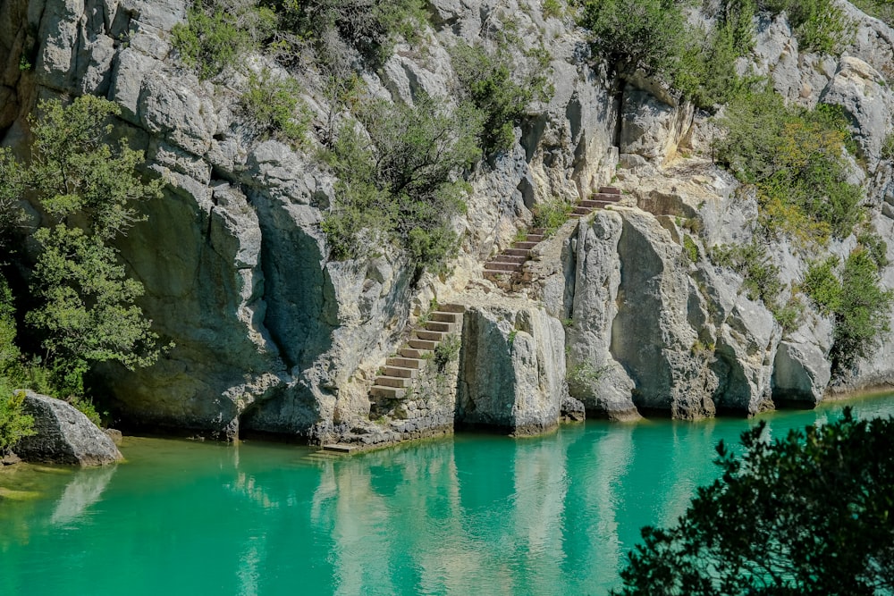 a body of water with steps leading up to a cliff