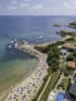 an aerial view of a beach with umbrellas