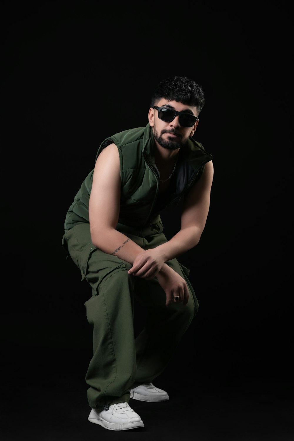 a man in a green outfit and sunglasses