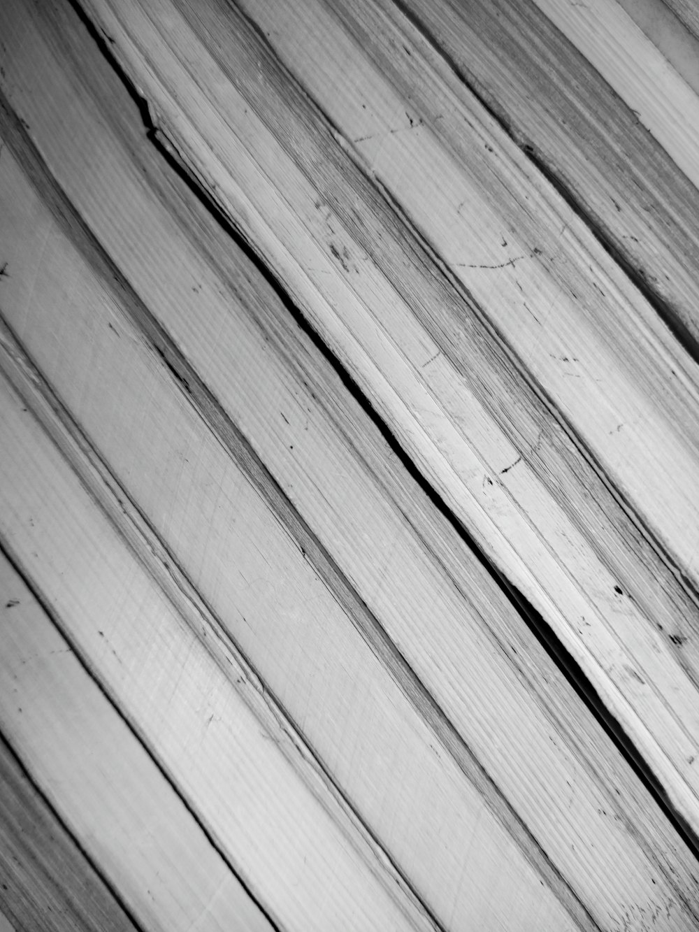 a black and white photo of a wooden surface