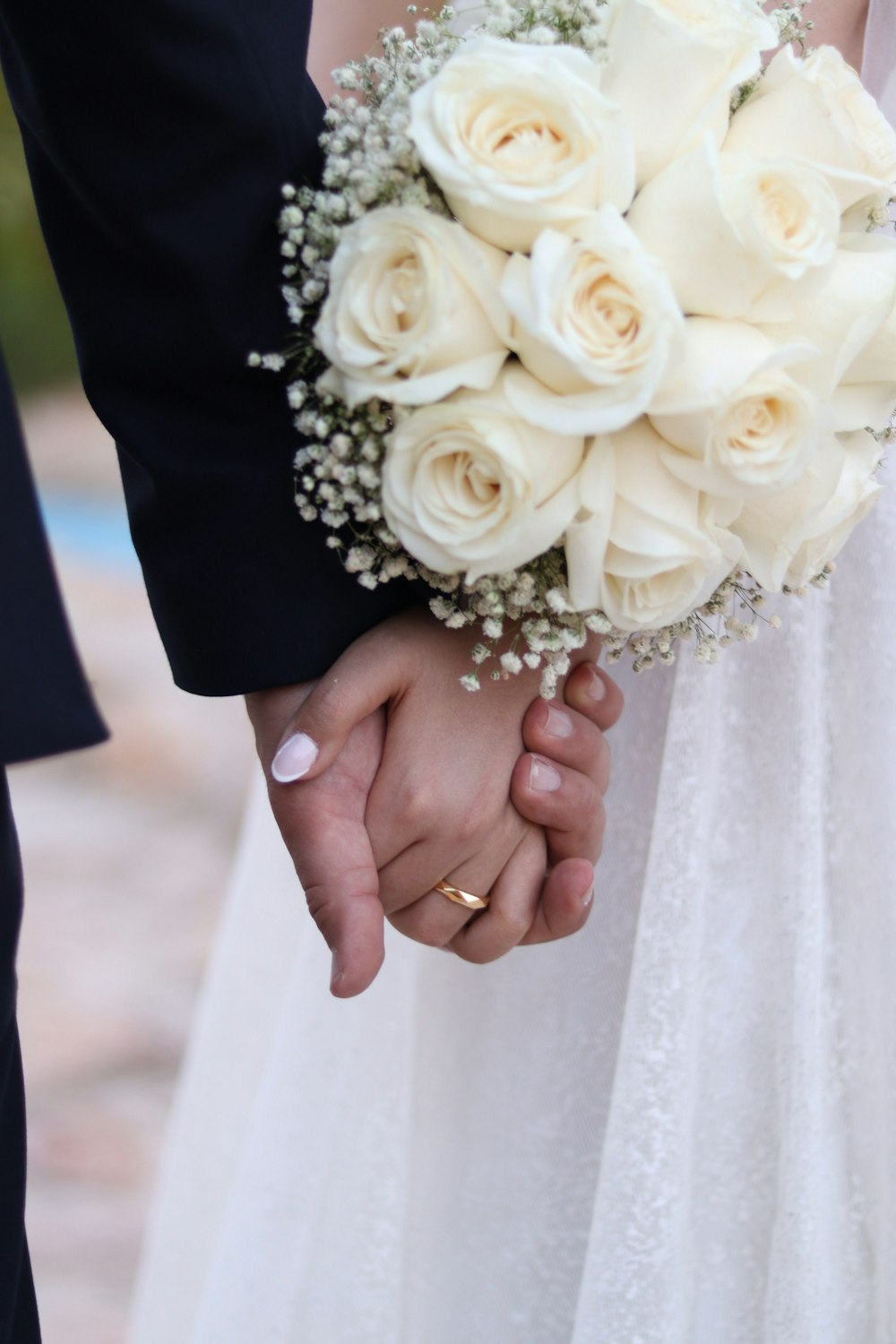 a close up of a person holding a bouquet of flowers