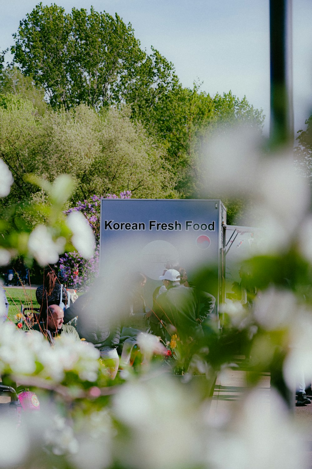 a group of people standing in front of a korean fresh food truck