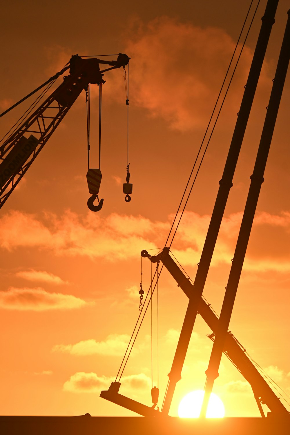 a crane is lifting a piece of equipment into the air