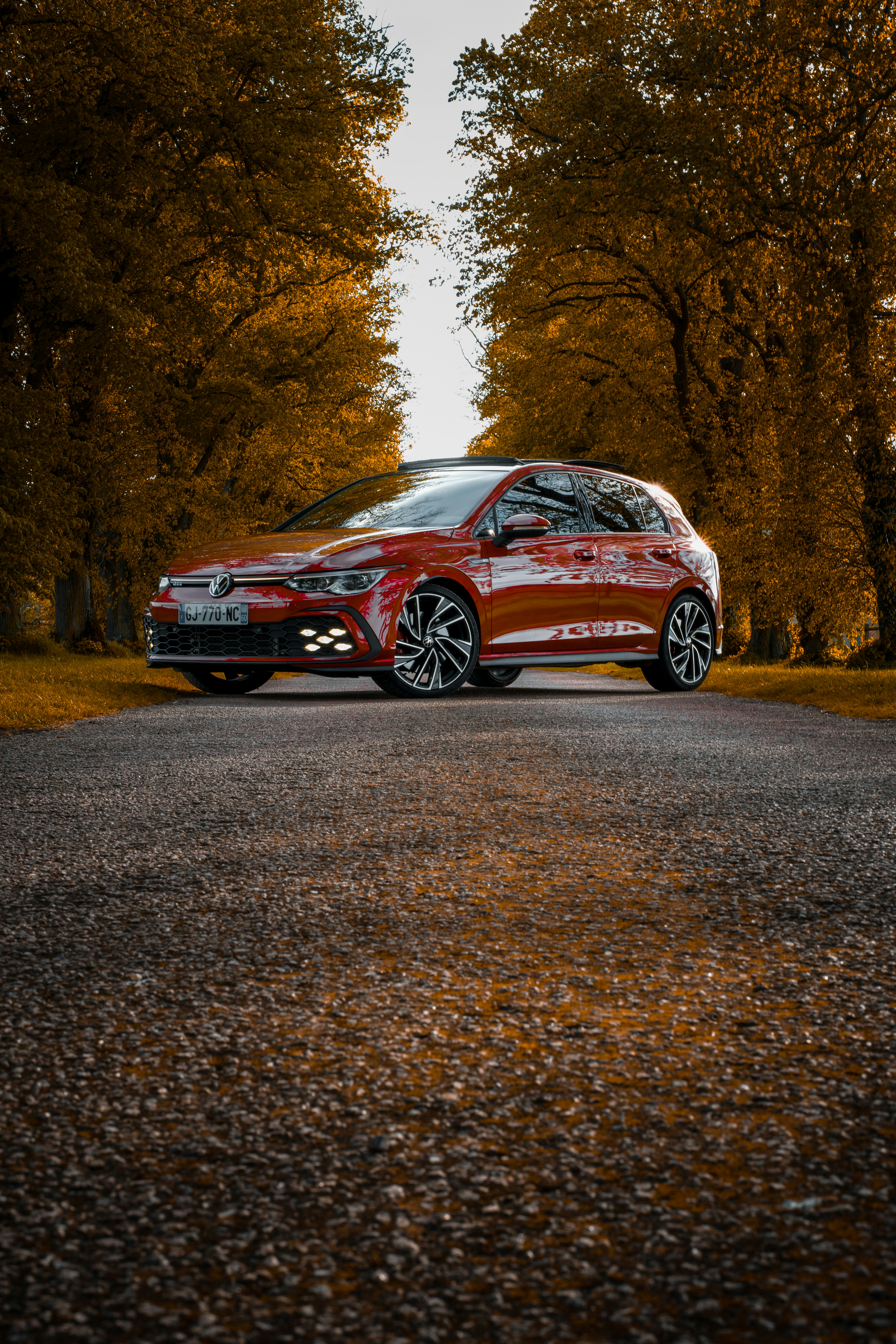 une voiture rouge garée sur le bord d’une route