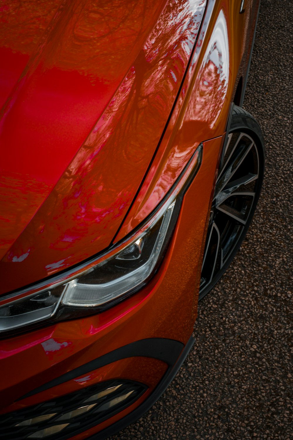 a close up of the front of a red car