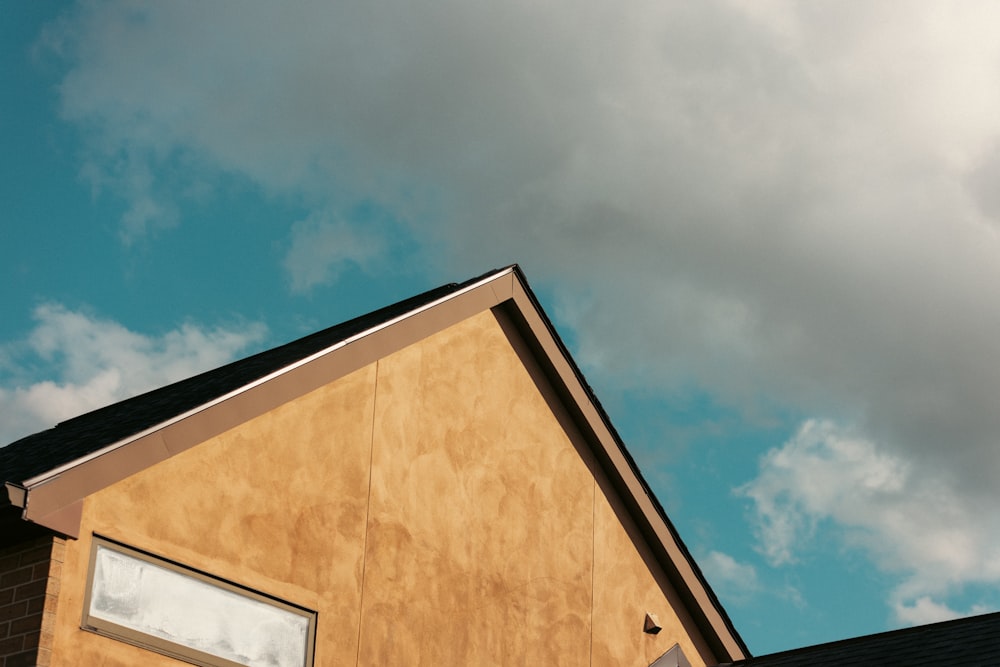 a house with a sky background and clouds