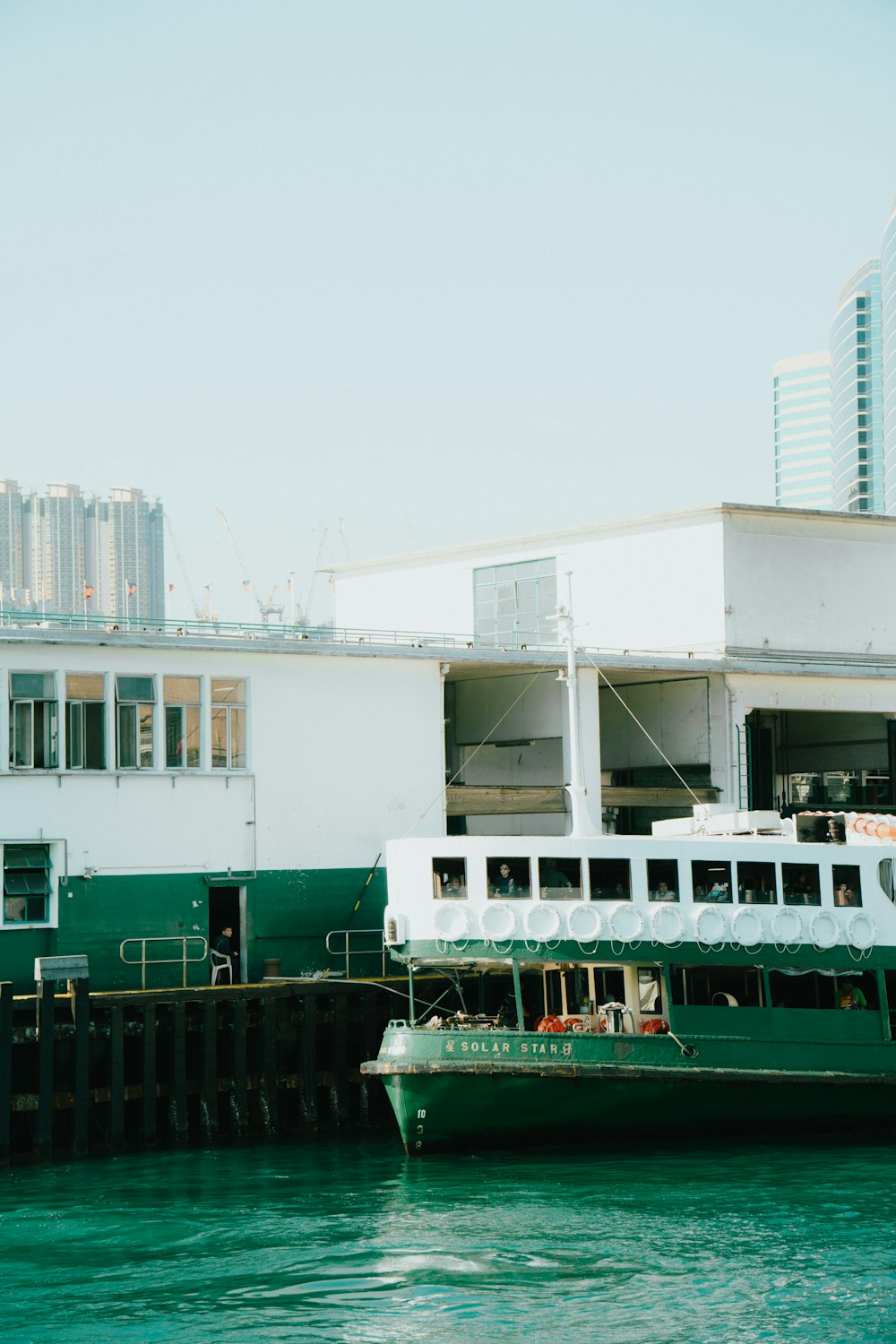 a large boat sitting in the water next to a dock