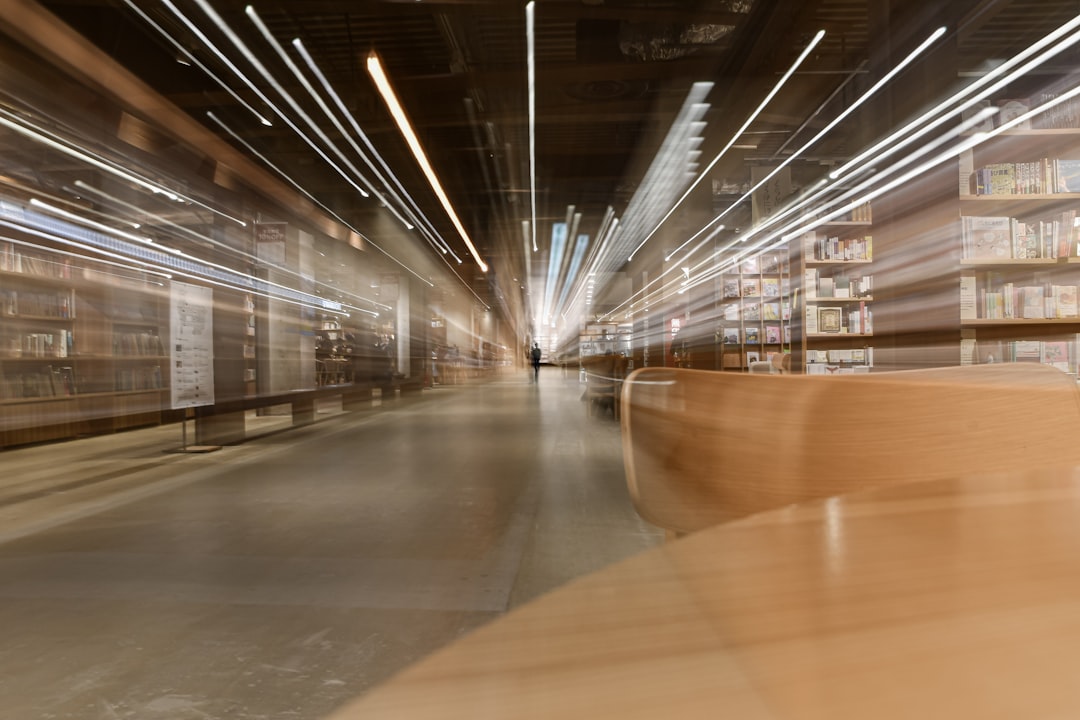 Pedestrians walking through a bookstore with a cafe attached.