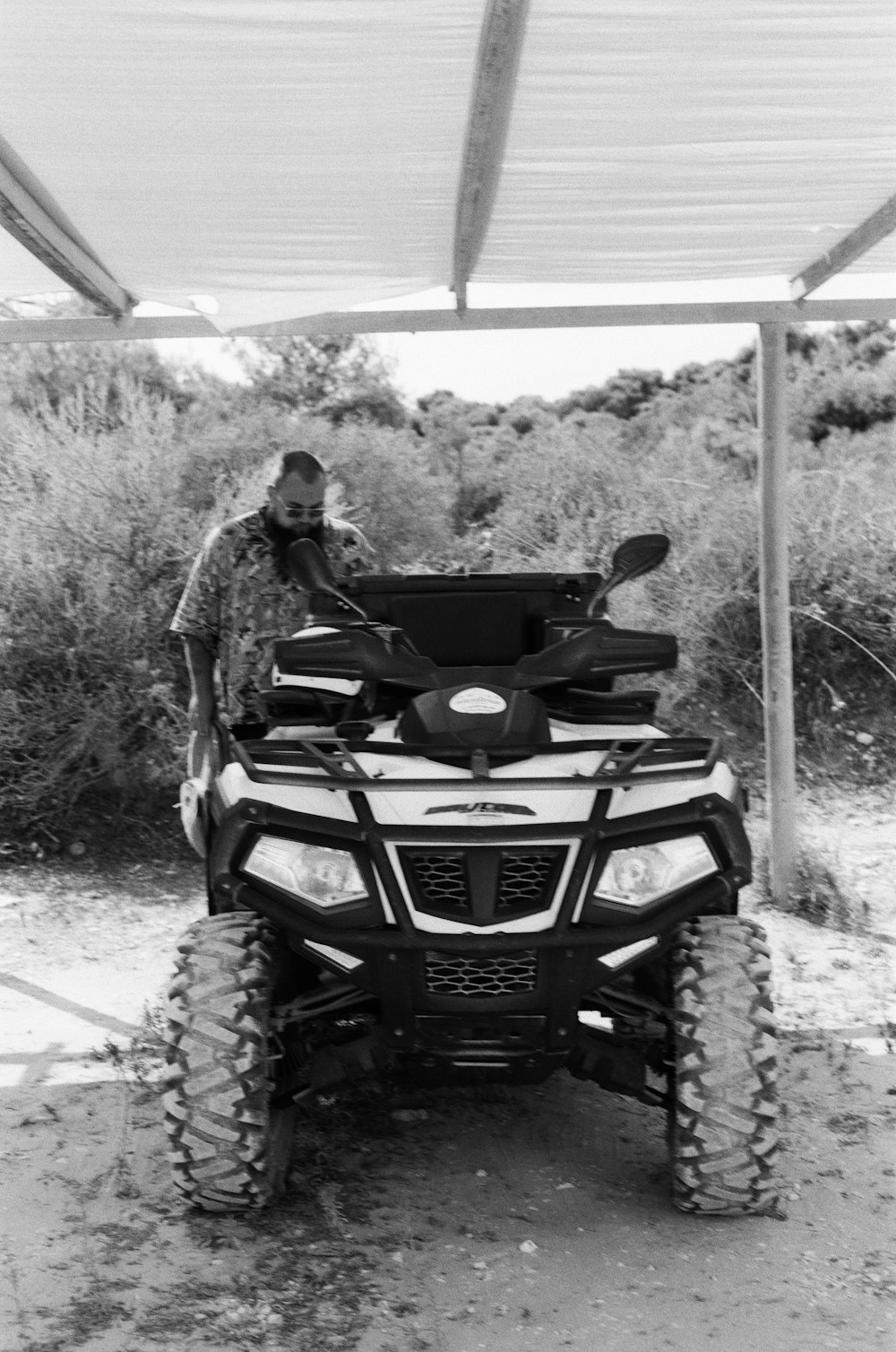 a man is sitting on a four wheeler