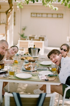 a group of people sitting around a table eating food