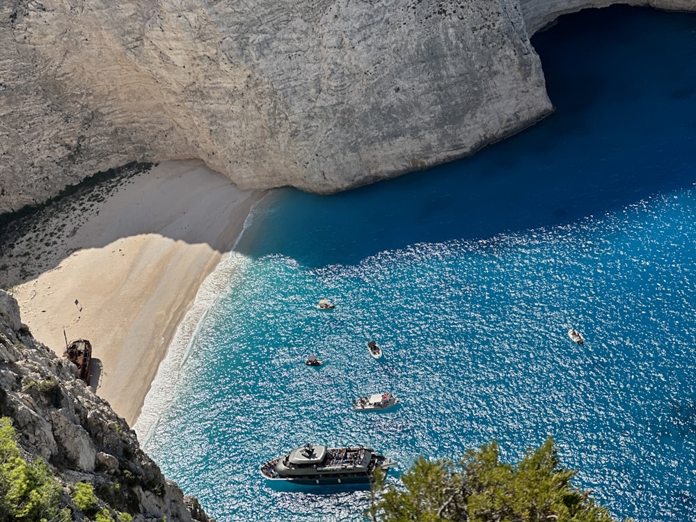 a boat in the water near a rocky cliff