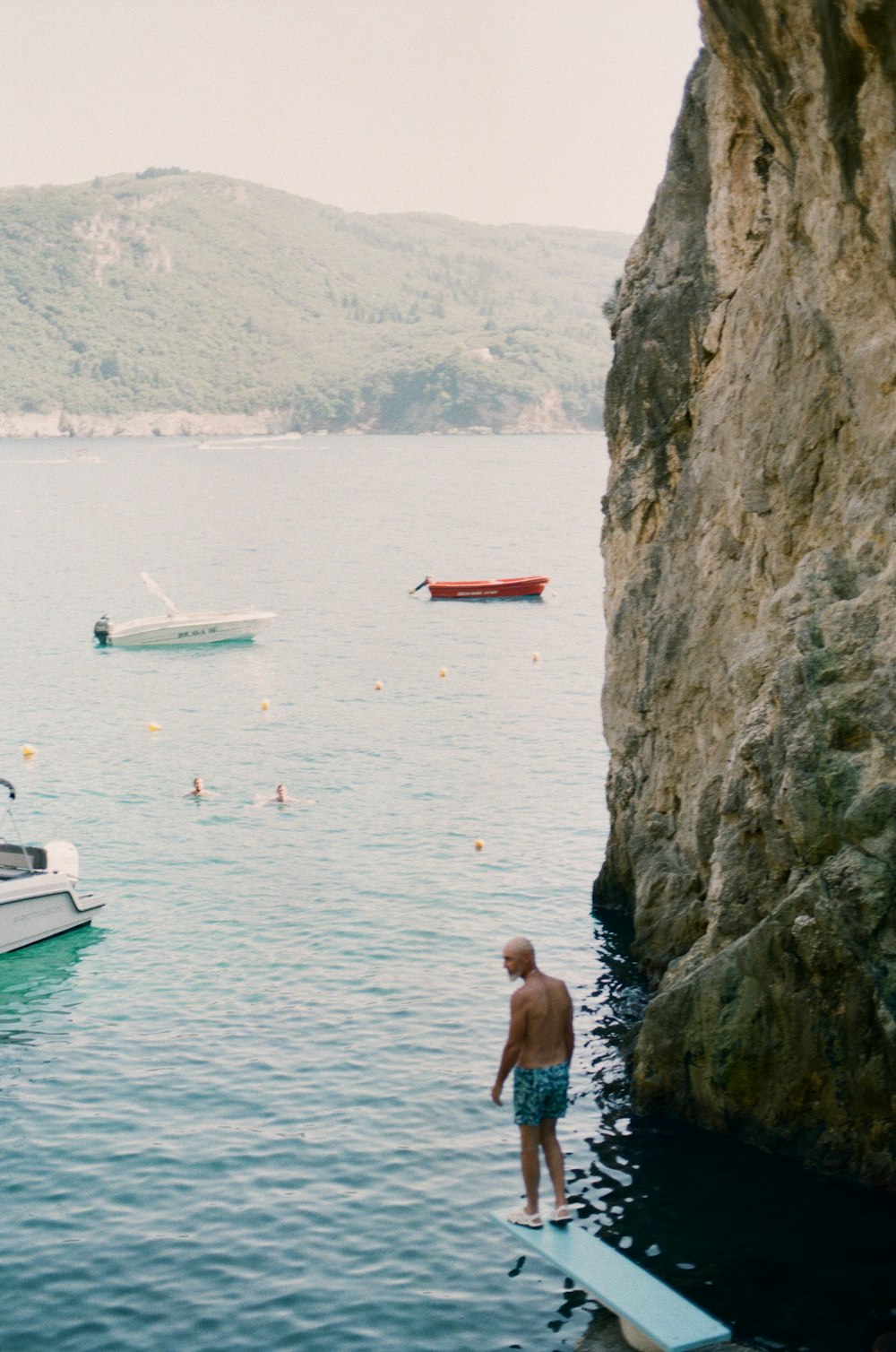 a man standing on a surfboard in the water