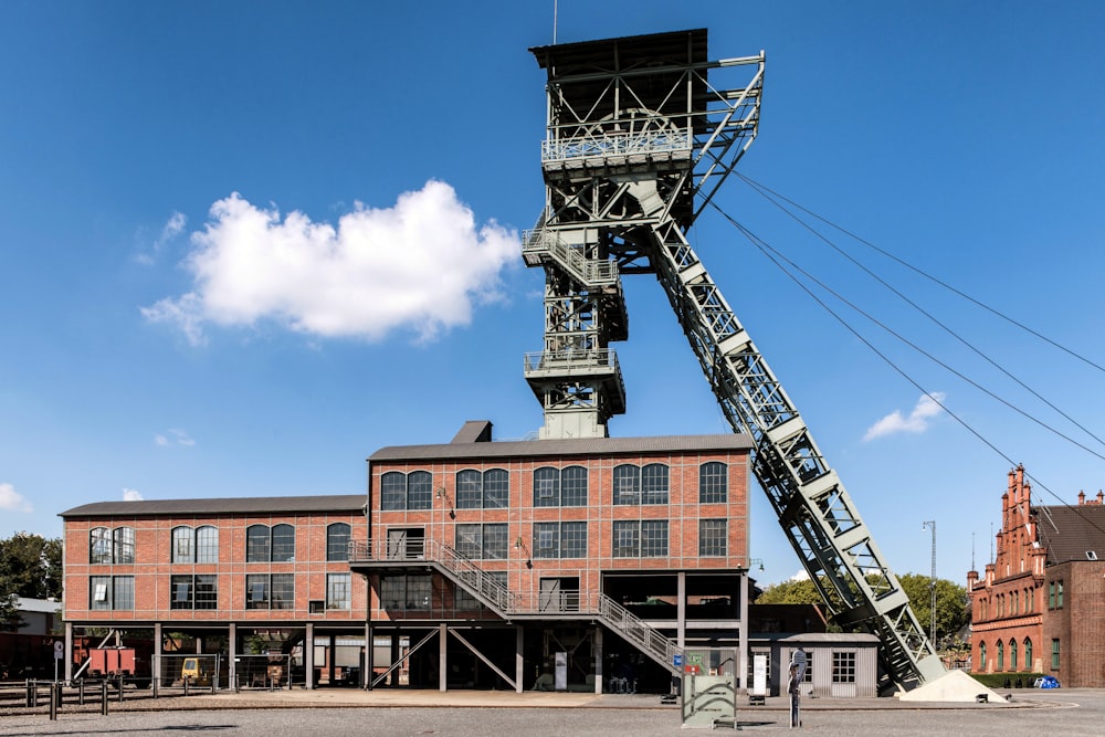 a tall metal structure sitting in the middle of a parking lot