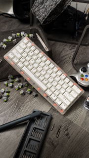 a computer keyboard sitting on top of a wooden table