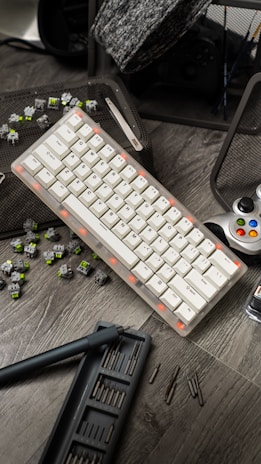 a computer keyboard sitting on top of a wooden table