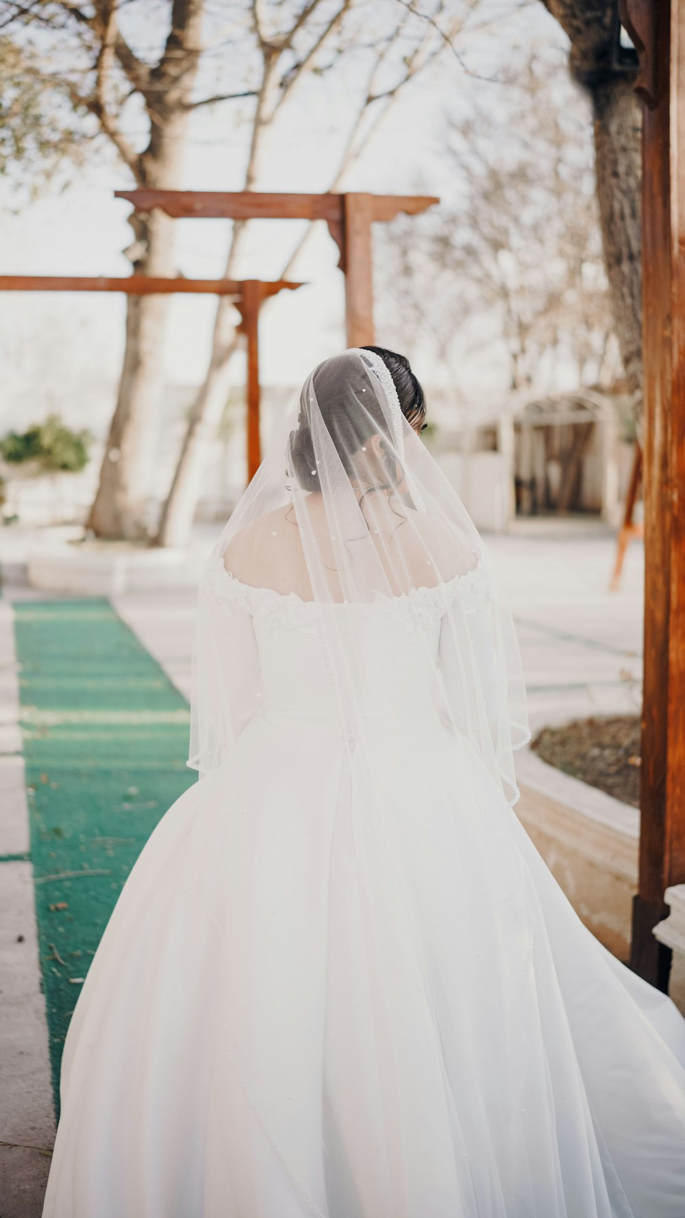 a woman in a white wedding dress and veil