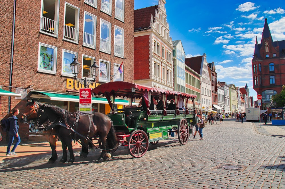 a horse drawn carriage on a cobblestone street