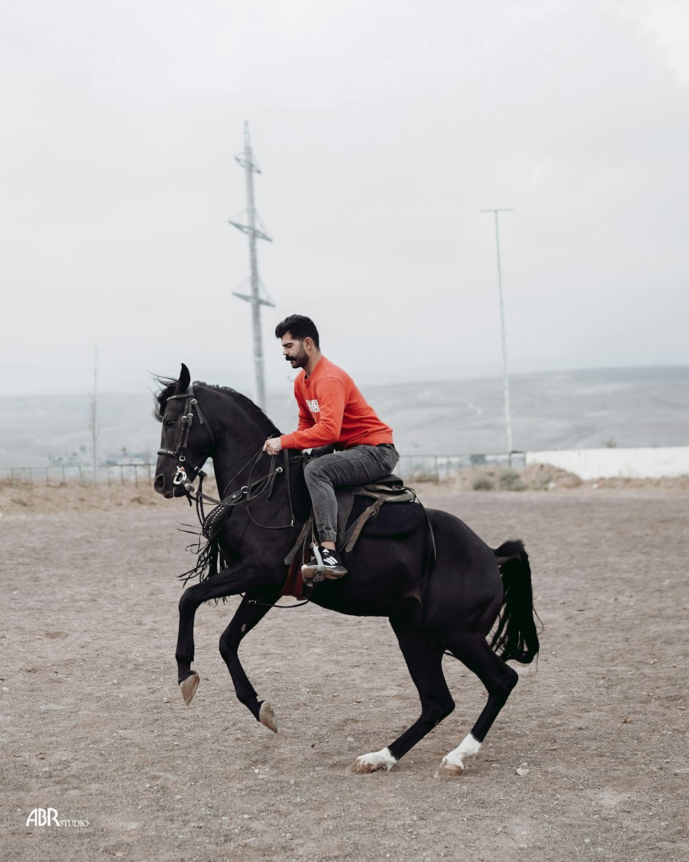 a man riding on the back of a black horse