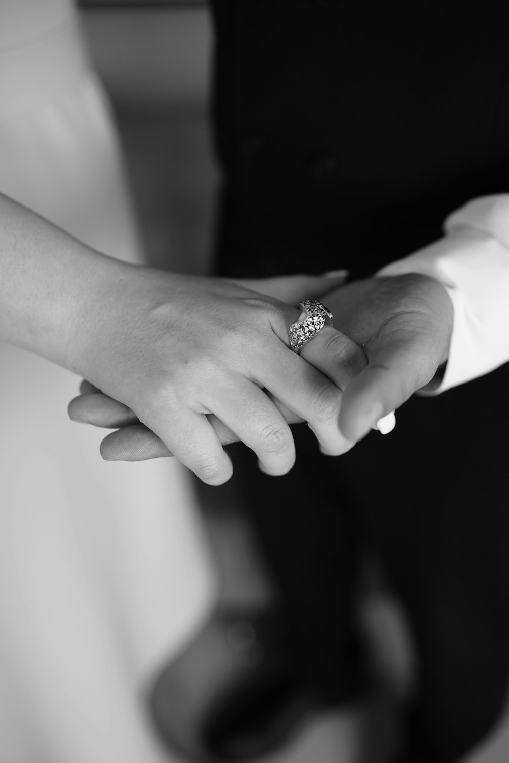 a close up of two people holding hands