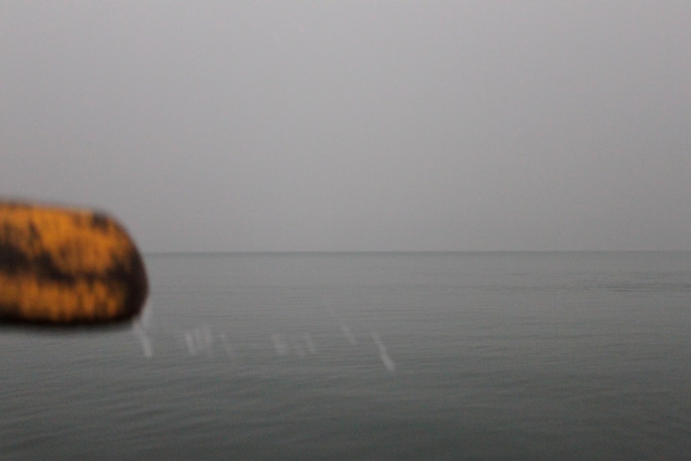 a blurry photo of a yellow object in the water