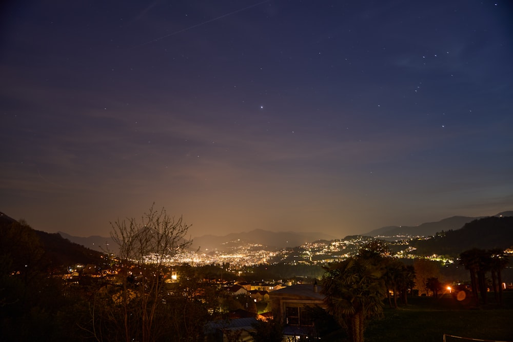 a view of a city at night from a hill