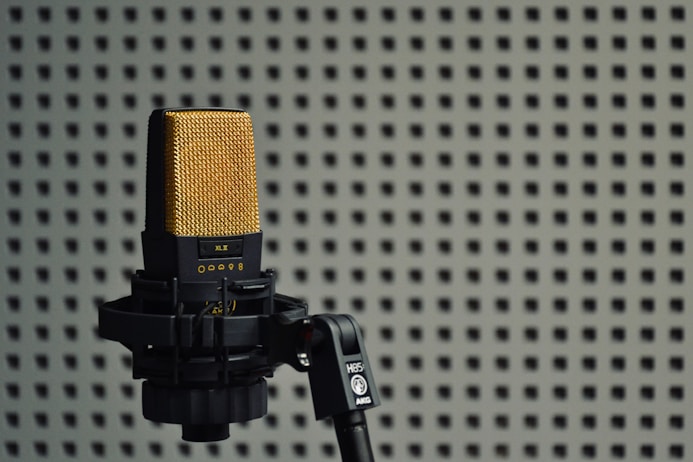 a microphone on a tripod in front of a wall