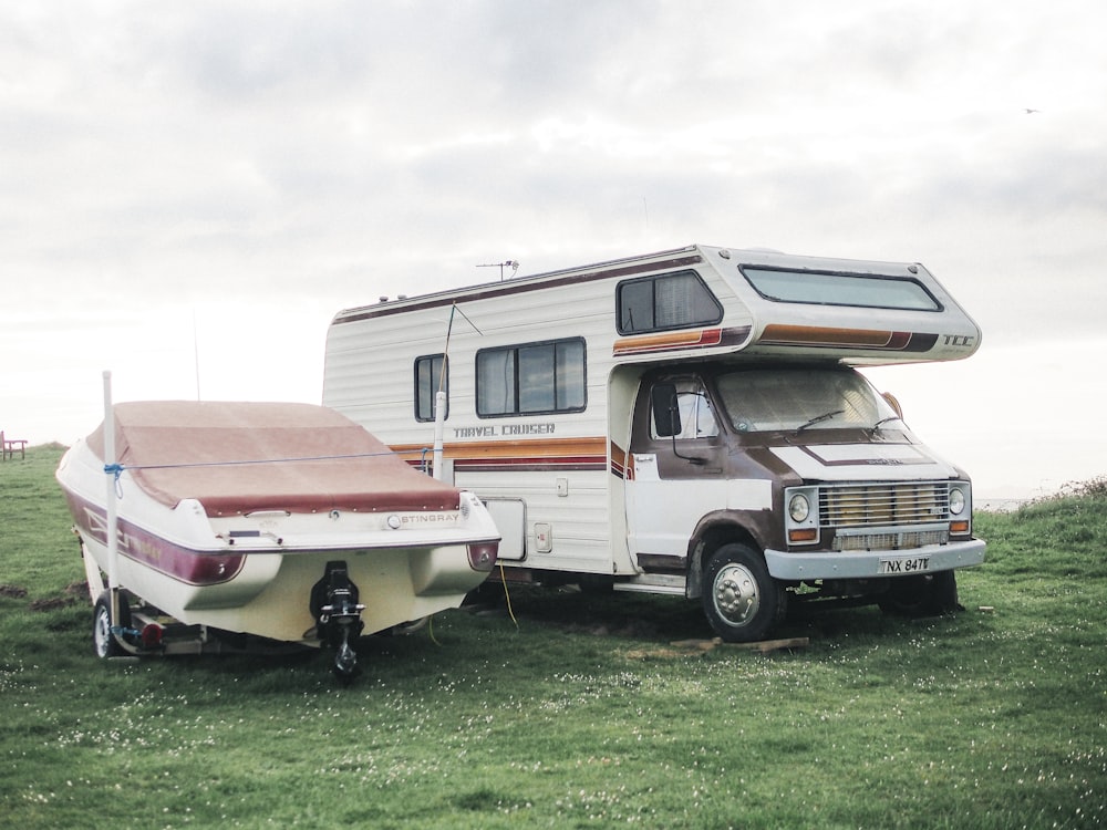 a motor home is parked next to a trailer