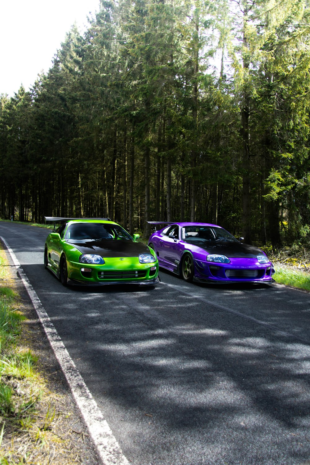 a couple of cars parked on the side of a road