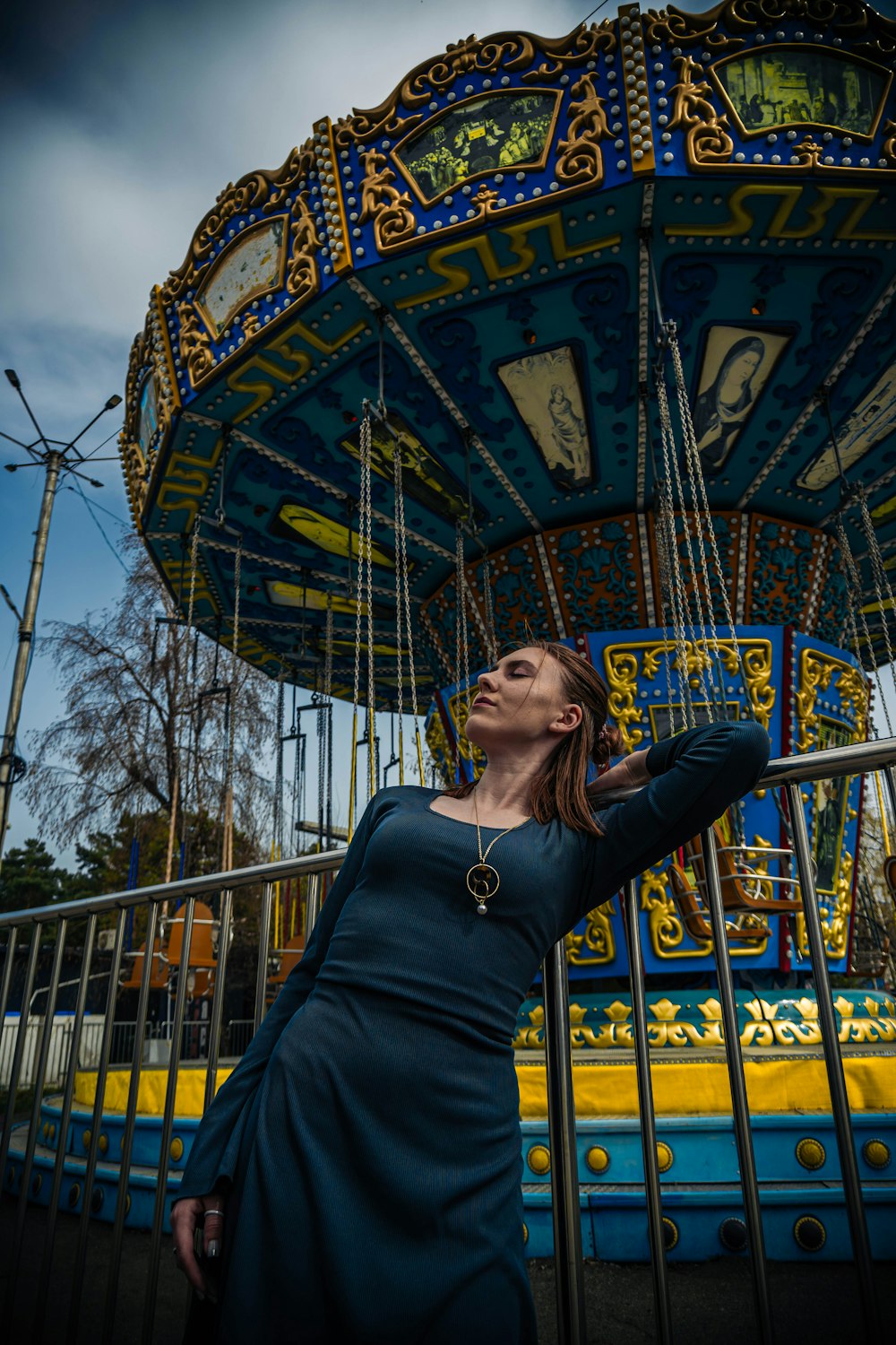 a woman standing in front of a carousel