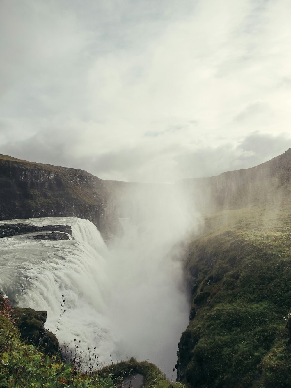 a view of a waterfall in the middle of a valley