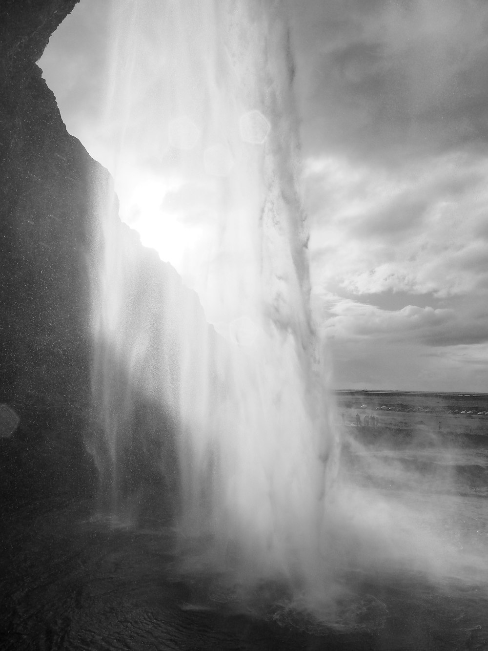 a black and white photo of a waterfall