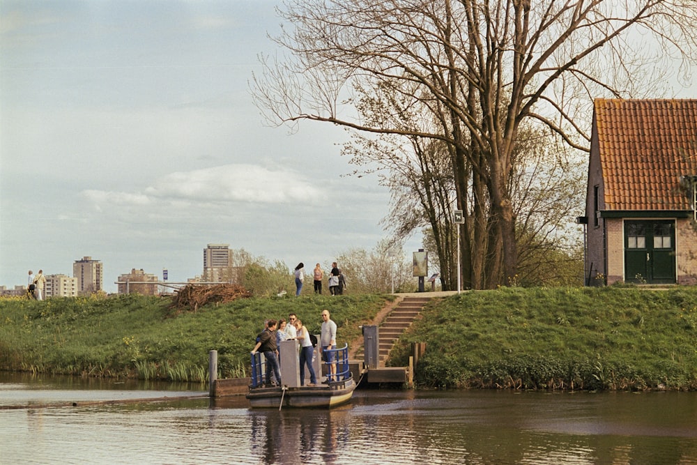 a group of people standing on a boat in a body of water