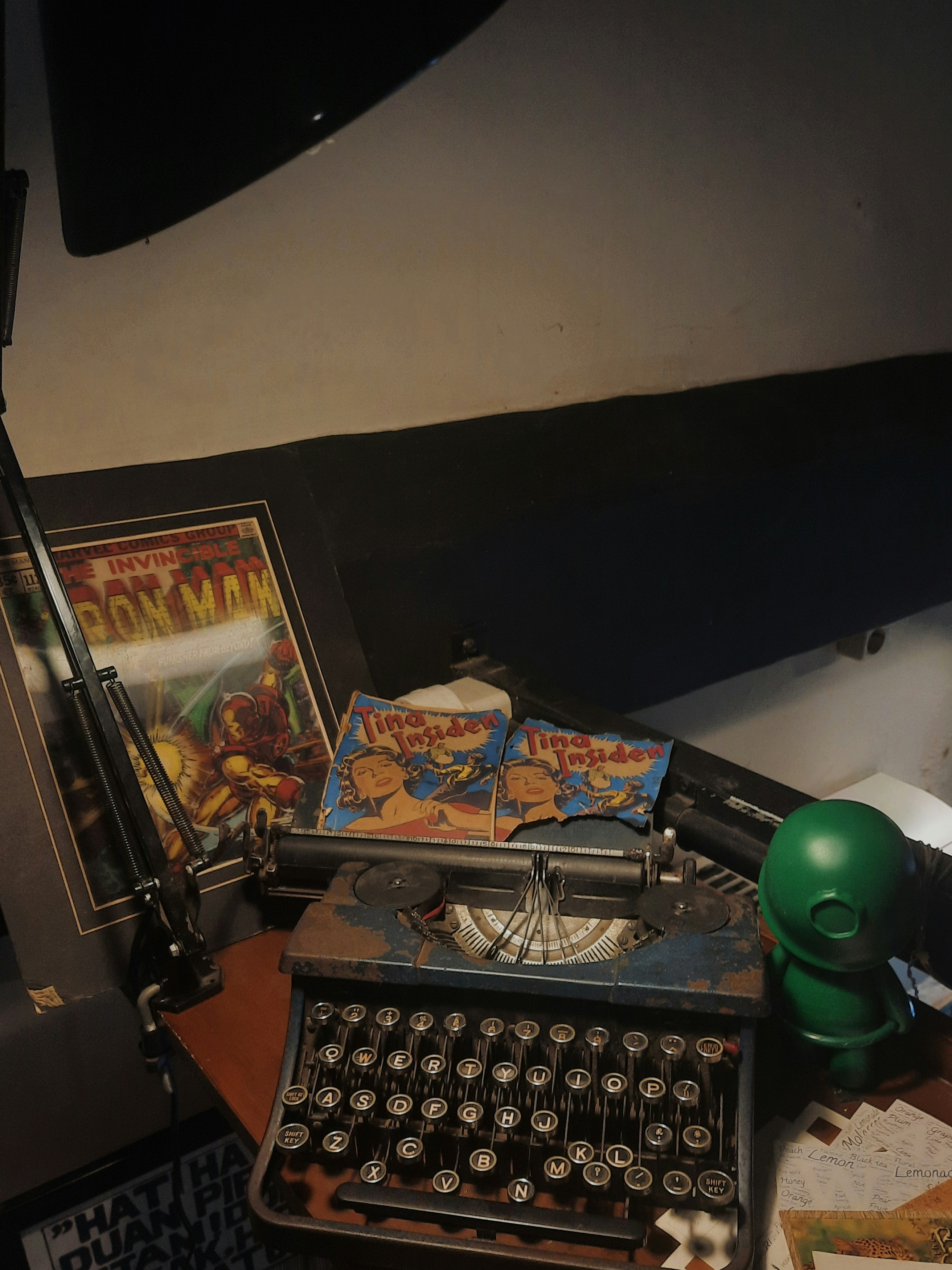 an old typewriter sitting on a desk next to a picture