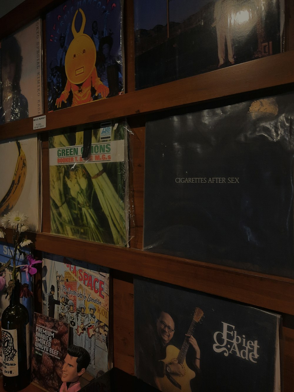 a wooden shelf filled with lots of posters