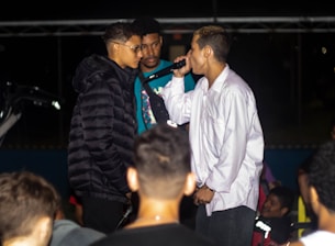 two men standing next to each other in front of a crowd